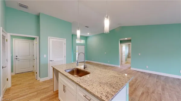 a bathroom with a granite countertop sink and mirror