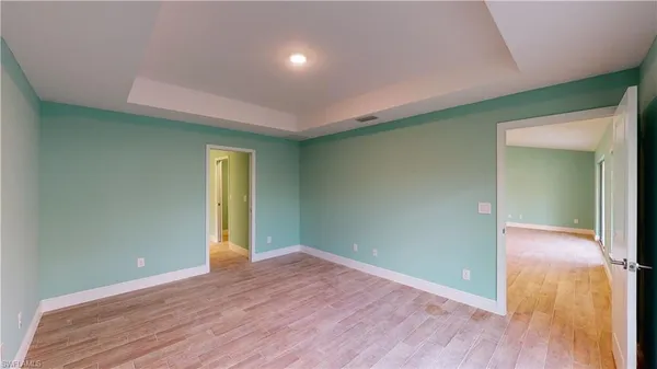 an empty room with wooden floor & closet