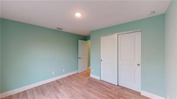 an empty room with wooden floor
