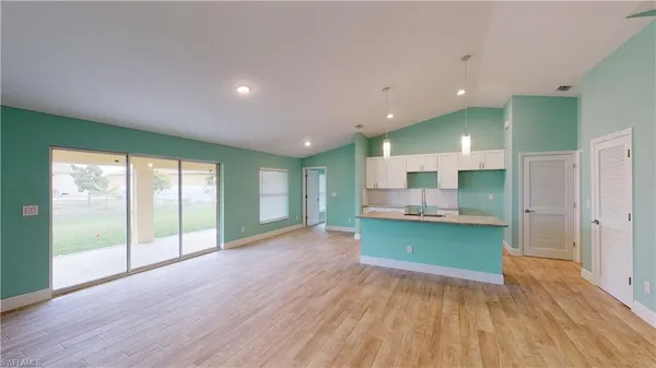 a open kitchen with stainless steel appliances granite countertop a large window