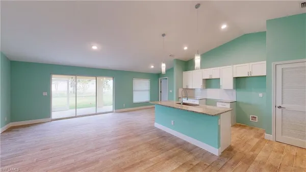 a view of kitchen with cabinets and wooden floor