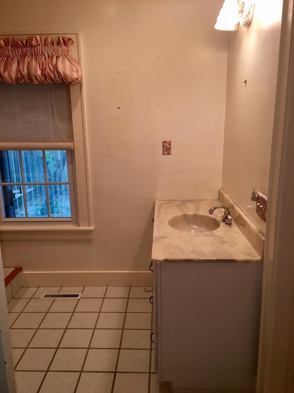 279 Mott Street Fall River, MA 02721 - Photo 11 of 19 a bathroom with a sink and a mirror