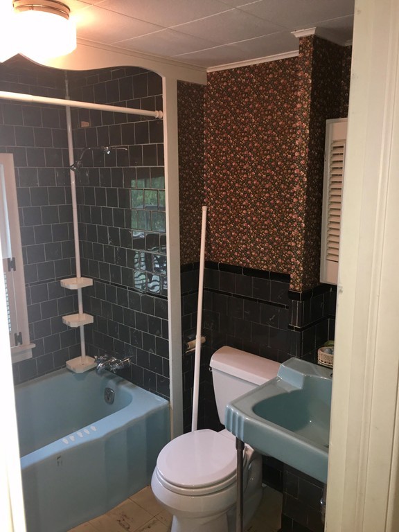 279 Mott Street Fall River, MA 02721 - Photo 13 of 19 a bathroom with a sink a toilet a mirror and shower