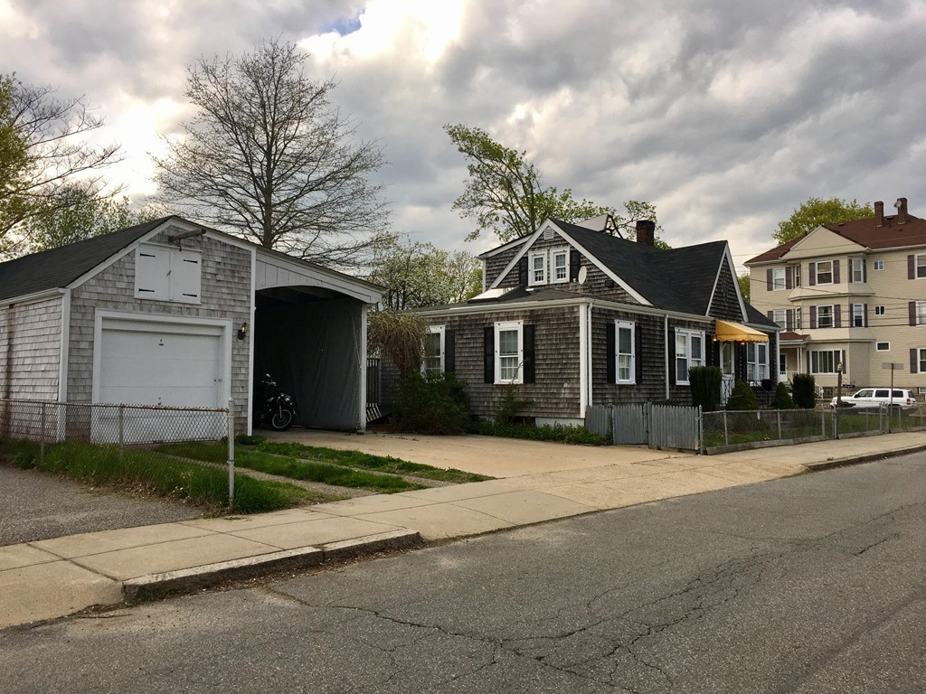 279 Mott Street Fall River, MA 02721 - Photo 2 of 19 a front view of a house with a garden