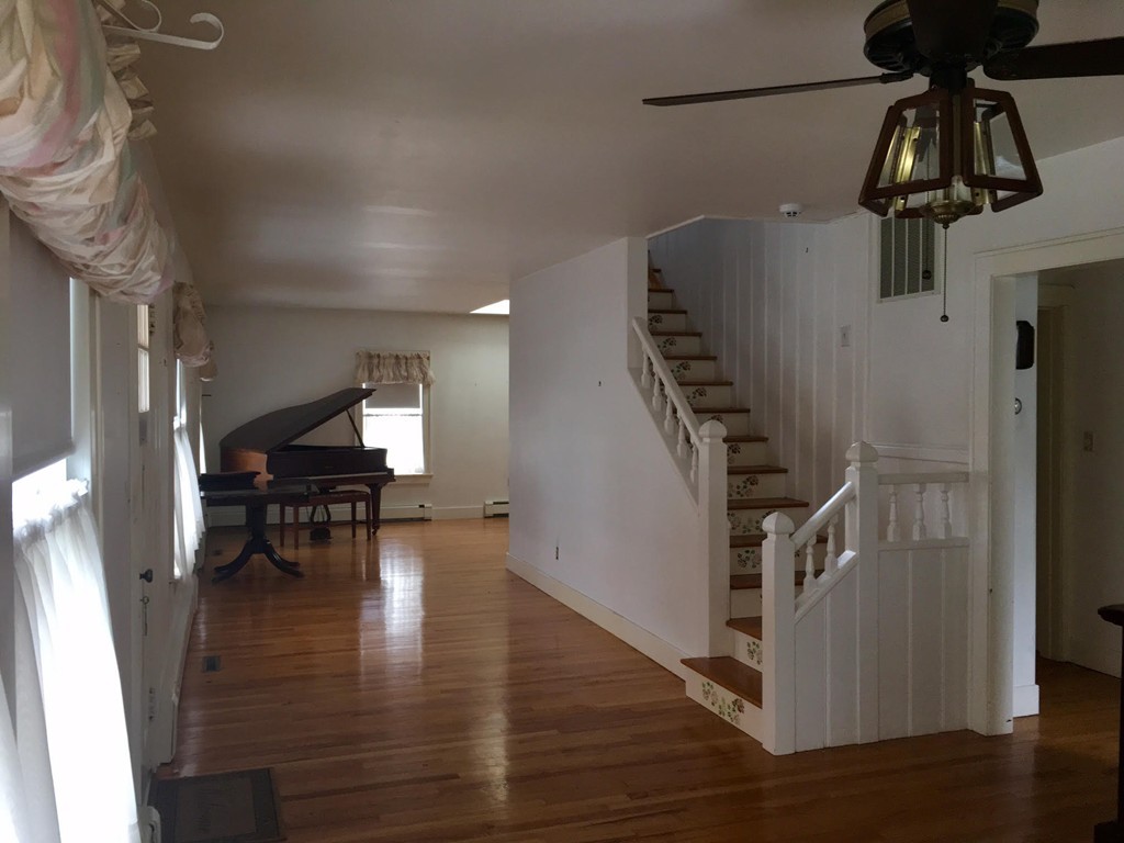 279 Mott Street Fall River, MA 02721 - Photo 5 of 19 a view of entryway and dining room with wooden floor