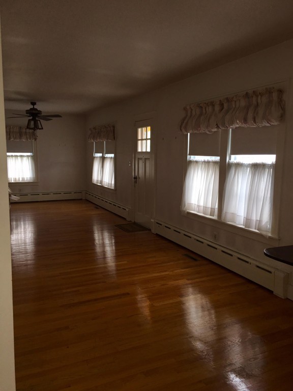 279 Mott Street Fall River, MA 02721 - Photo 6 of 19 a view of empty room with wooden floor and fan