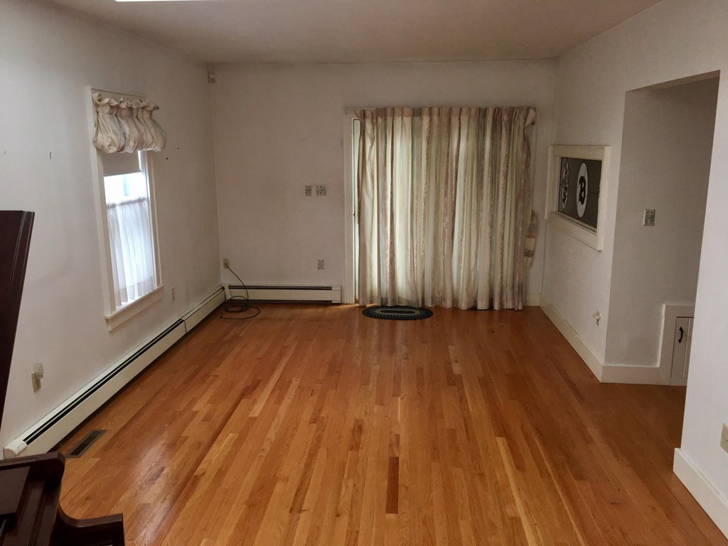 279 Mott Street Fall River, MA 02721 - Photo 7 of 19 an empty room with wooden floor and windows