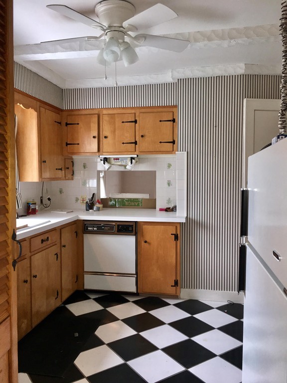 279 Mott Street Fall River, MA 02721 - Photo 8 of 19 a kitchen with a stove a sink and a refrigerator