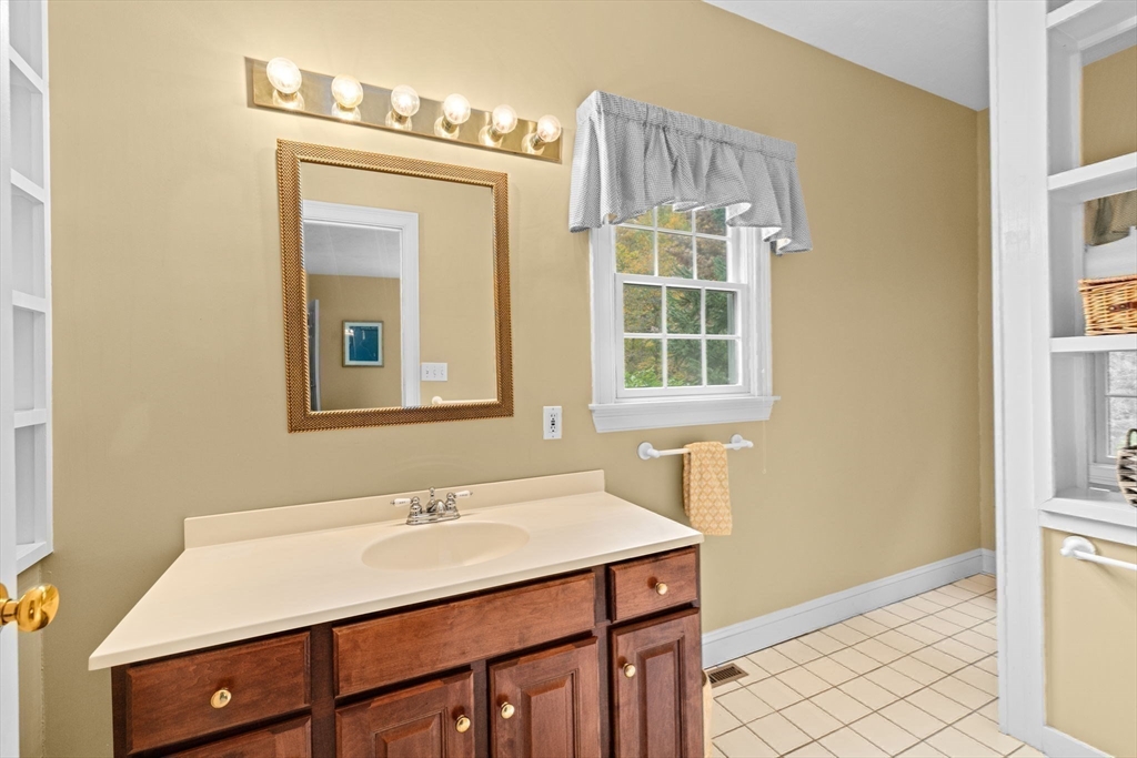 9 Forest Scituate Ma, Unit 9 Scituate, MA 02066 - Photo 19 of 41 a bathroom with a sink vanity and a mirror