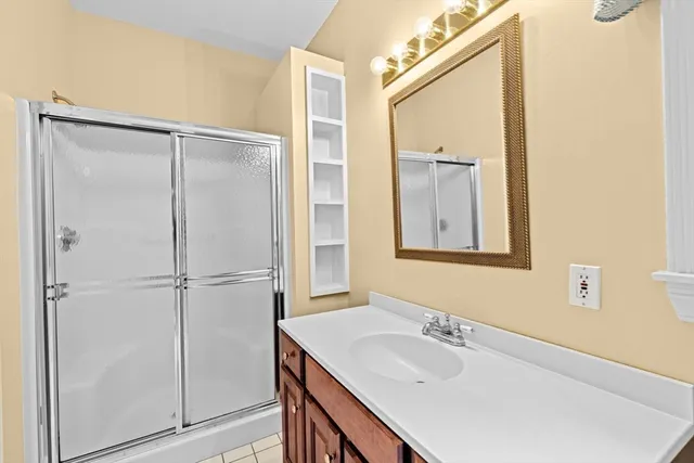 a bathroom with a granite countertop sink mirror and vanity