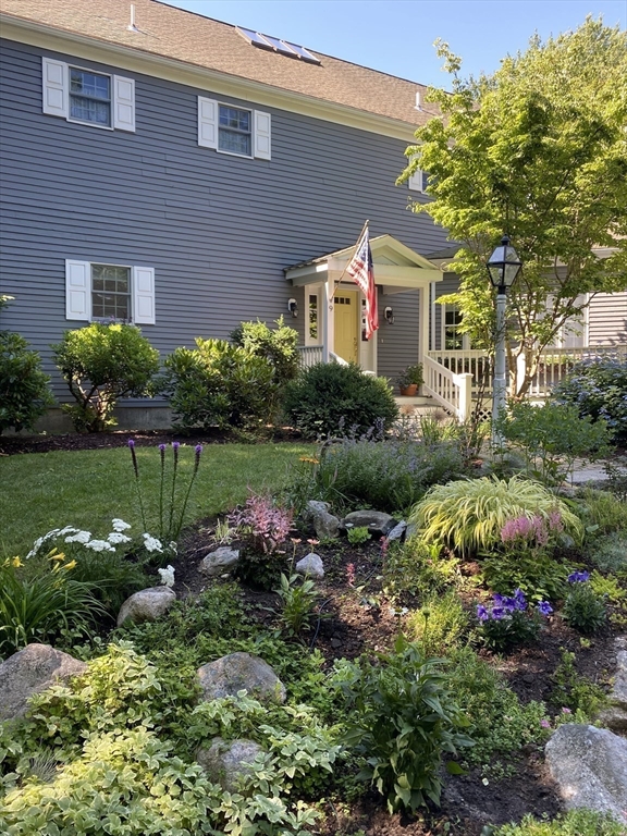 9 Forest Scituate Ma, Unit 9 Scituate, MA 02066 - Photo 37 of 41 a front view of a house with a yard and outdoor seating