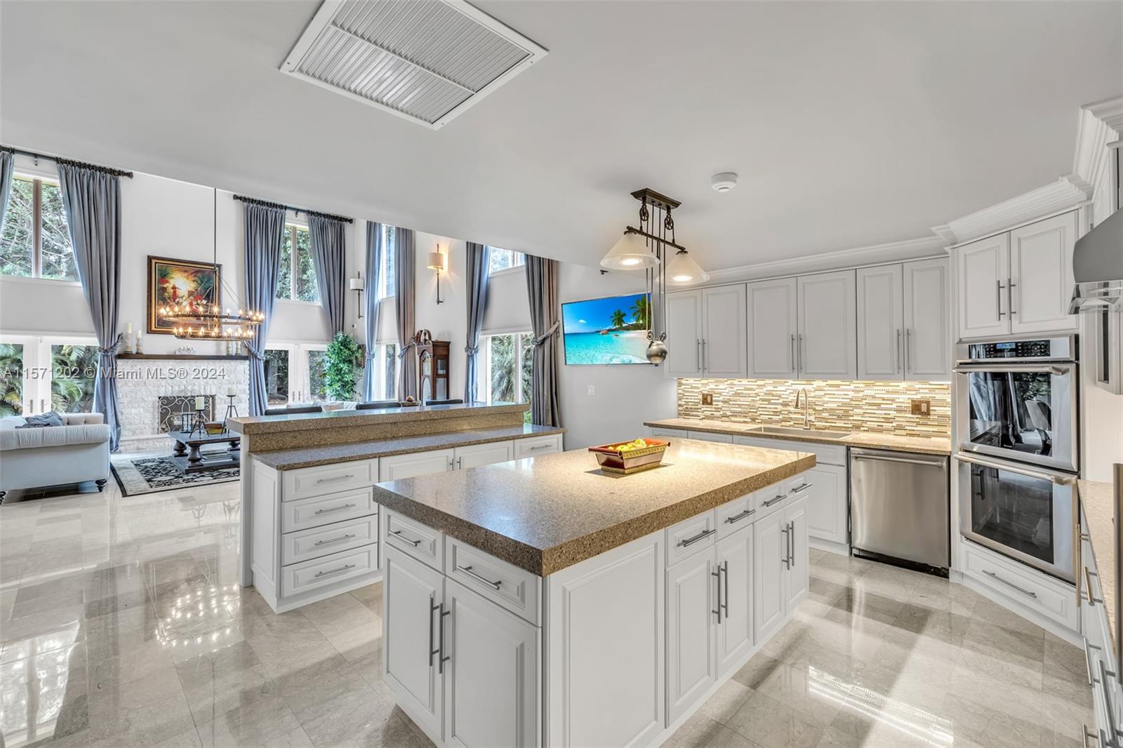 14600 Marvin Lane Southwest Ranches, FL 33330 - Photo 27 of 72 a kitchen that has a sink a stove and chairs