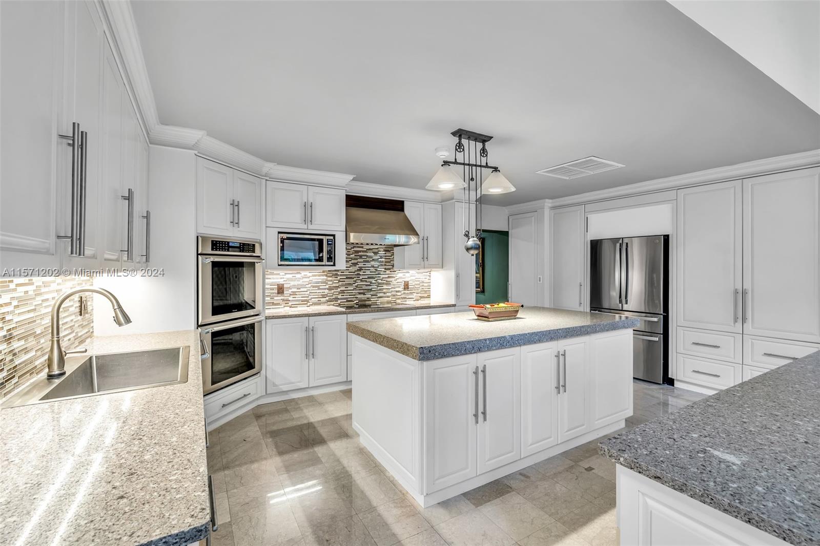 14600 Marvin Lane Southwest Ranches, FL 33330 - Photo 28 of 72 a kitchen with stainless steel appliances granite countertop a sink stove and refrigerator
