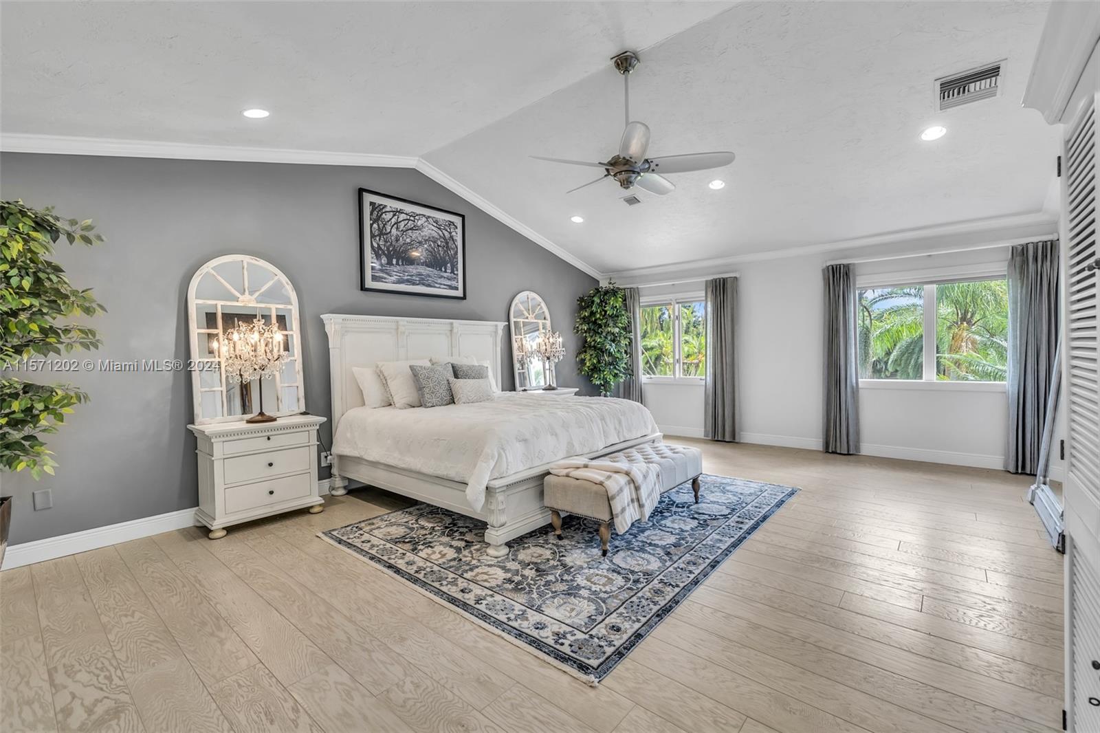 14600 Marvin Lane Southwest Ranches, FL 33330 - Photo 30 of 72 a spacious bedroom with a large bed and a chandelier