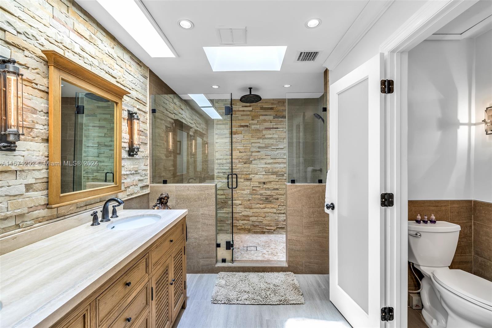 14600 Marvin Lane Southwest Ranches, FL 33330 - Photo 33 of 72 a bathroom with a granite countertop sink toilet and shower