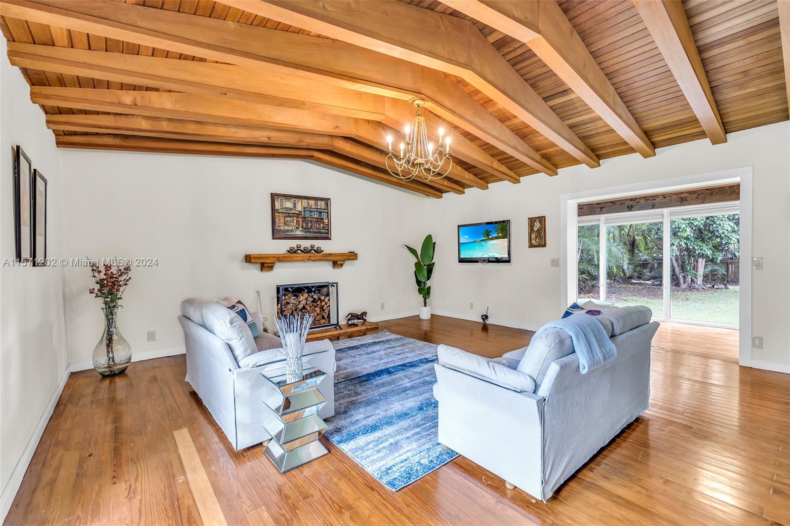 14600 Marvin Lane Southwest Ranches, FL 33330 - Photo 38 of 72 a living room with furniture and a chandelier