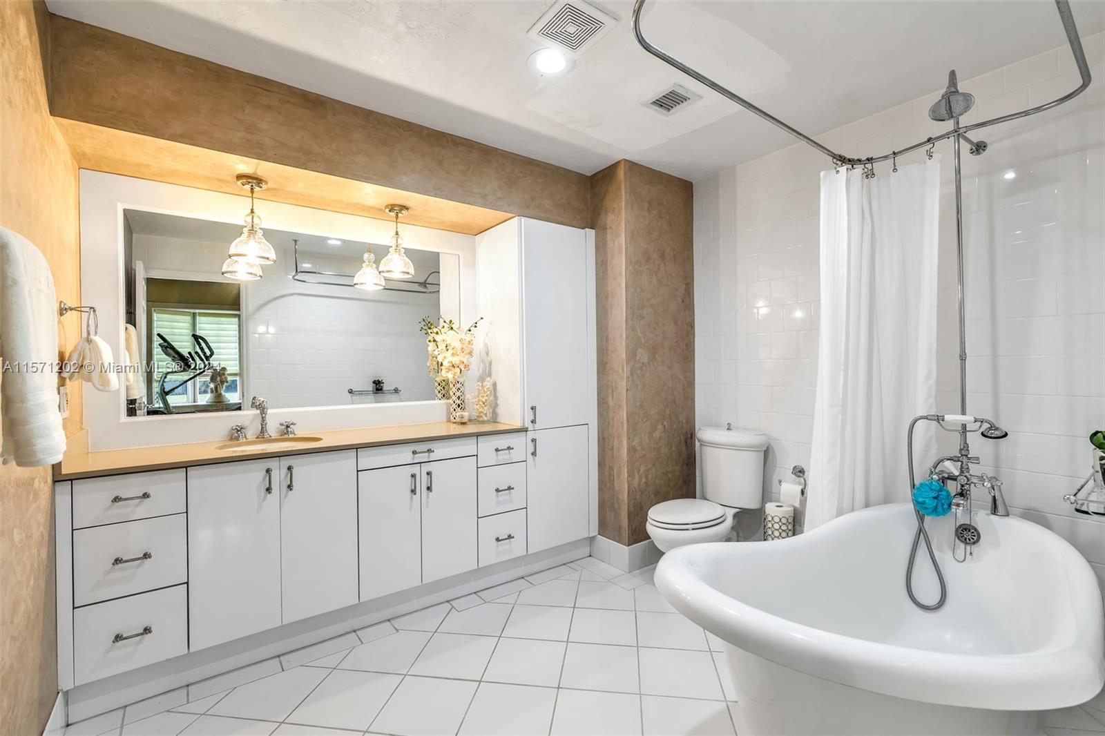 14600 Marvin Lane Southwest Ranches, FL 33330 - Photo 42 of 72 a spacious bathroom with a double vanity sink a mirror and a bathtub