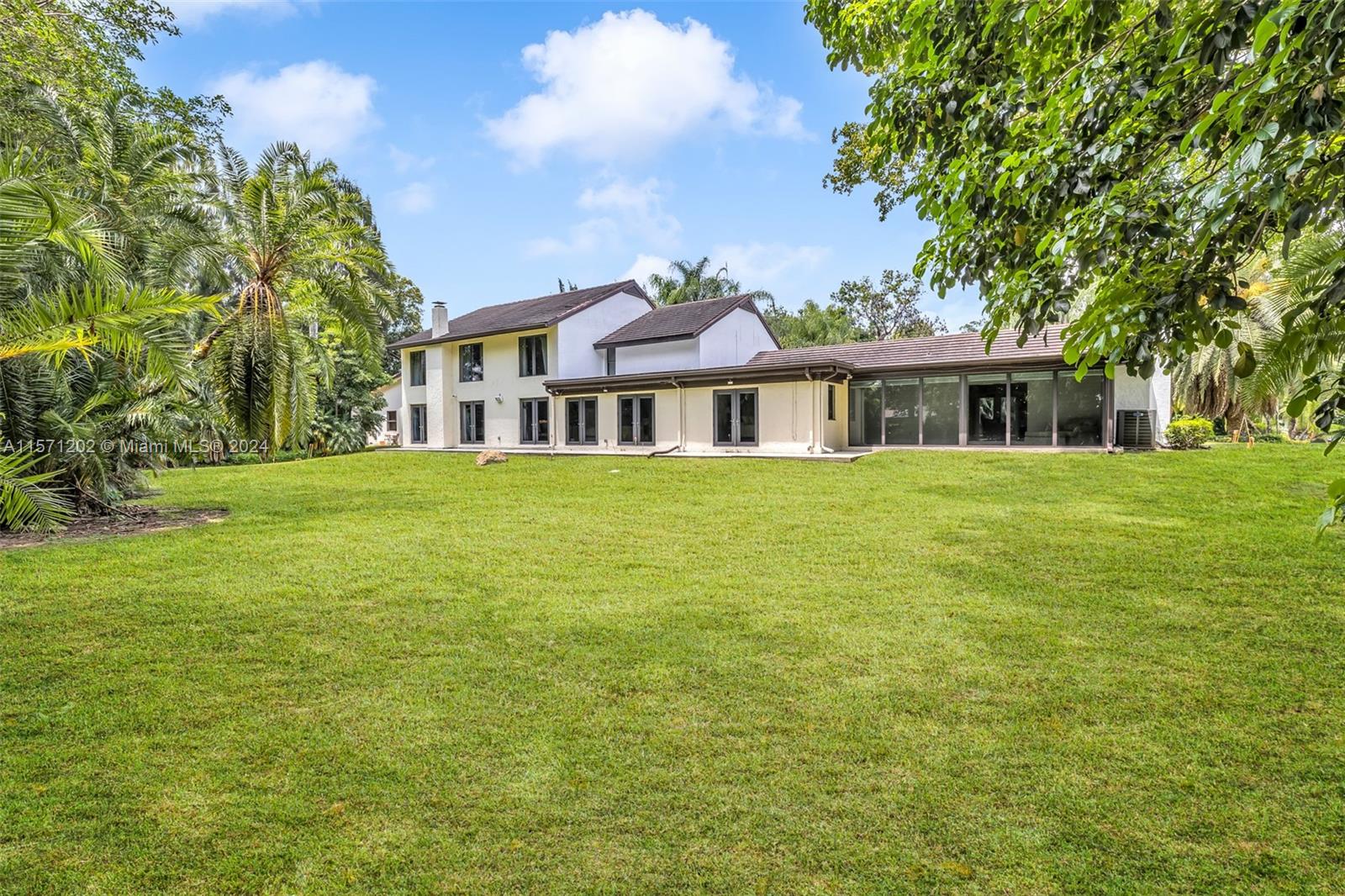 14600 Marvin Lane Southwest Ranches, FL 33330 - Photo 56 of 72 a front view of a house with a garden