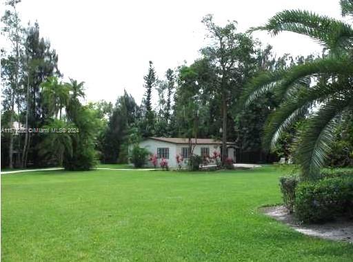 14600 Marvin Lane Southwest Ranches, FL 33330 - Photo 70 of 72 a view of a house with a big yard and large trees