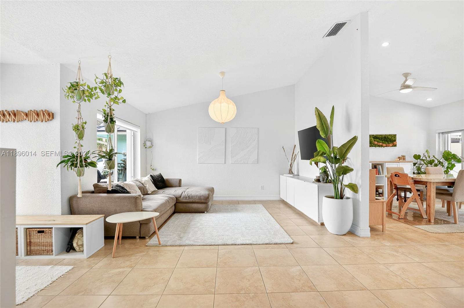 752 Northwest 134th Avenue Miami, FL 33182 - Photo 1 of 47 a living room with furniture a chandelier and a dining table