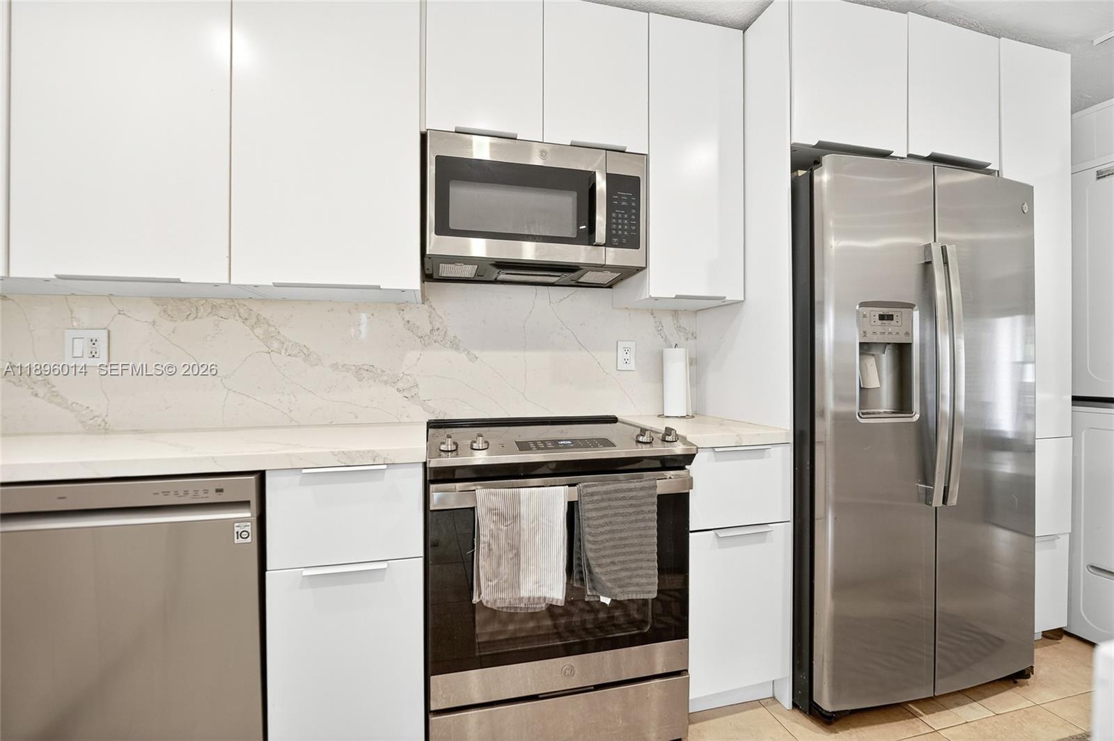 752 Northwest 134th Avenue Miami, FL 33182 - Photo 14 of 47 a kitchen with a refrigerator sink and microwave