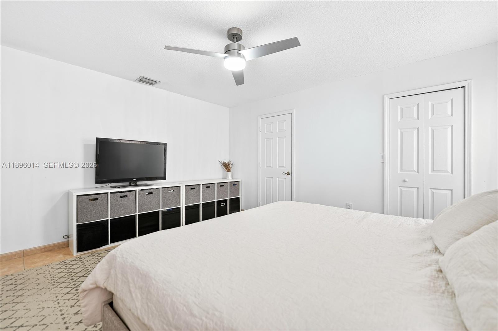 752 Northwest 134th Avenue Miami, FL 33182 - Photo 16 of 47 a bedroom with a bed and a flat screen tv