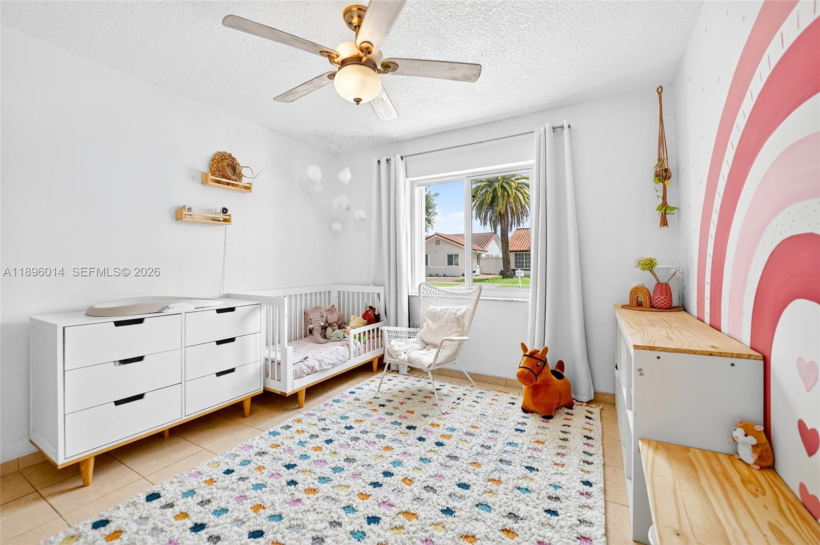 752 Northwest 134th Avenue Miami, FL 33182 - Photo 20 of 47 a room with a baby crib a chandelier and a couch