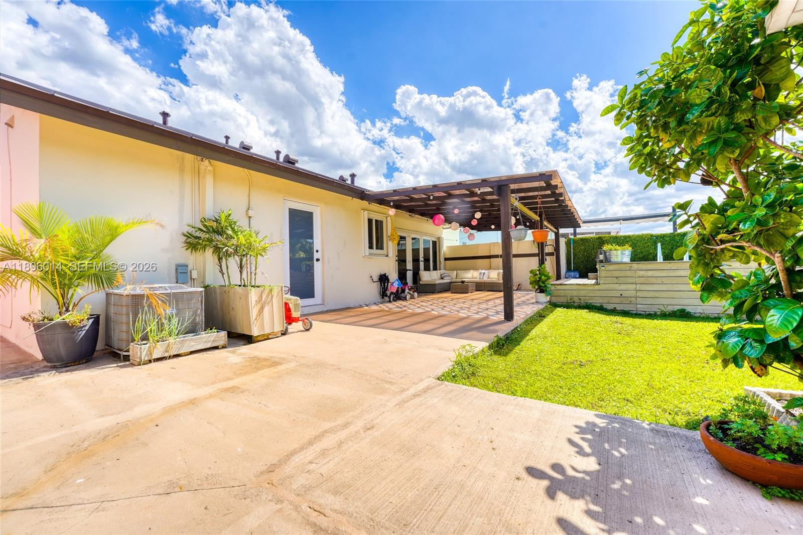 752 Northwest 134th Avenue Miami, FL 33182 - Photo 29 of 47 a view of a patio with a table and chairs under an umbrella