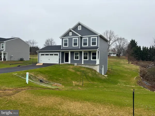 a front view of a house with a yard table and chairs