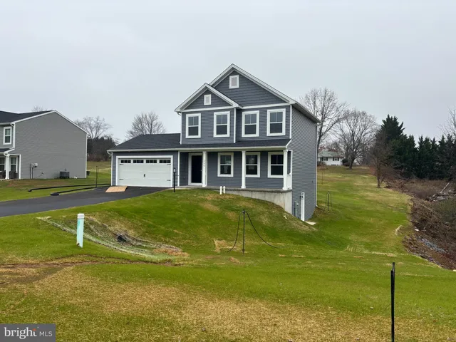 a front view of a house with a yard table and chairs