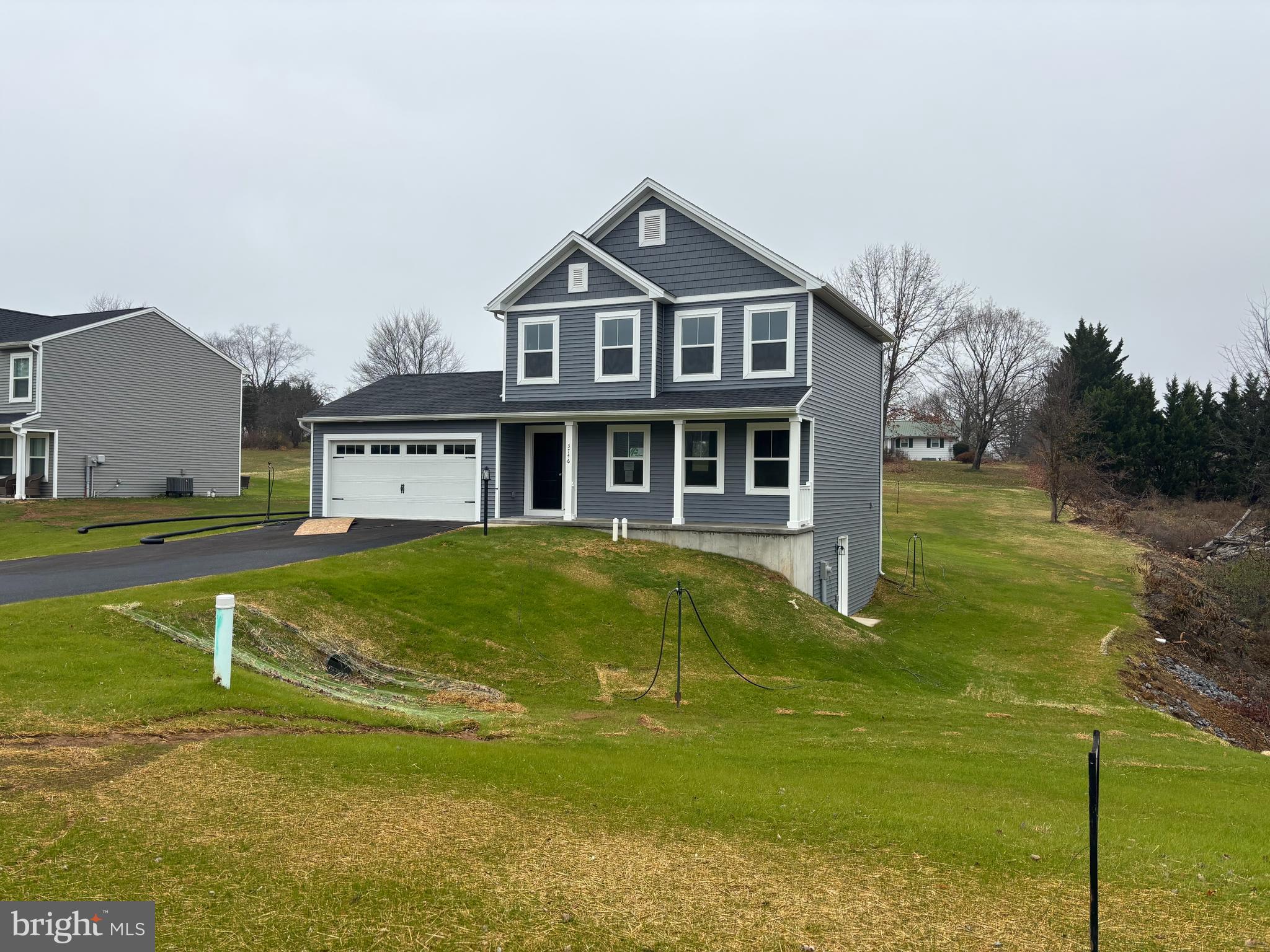 a front view of a house with a yard table and chairs