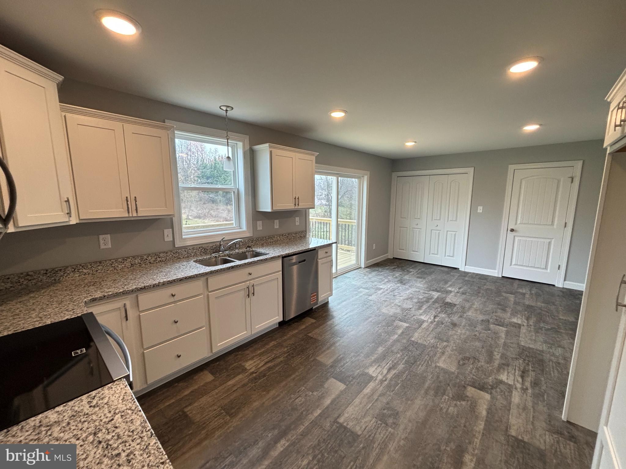 3746 Percy Avenue Chambersburg, PA 17202 - Photo 7 of 8 a large kitchen with granite countertop a stove a sink a window and white cabinets