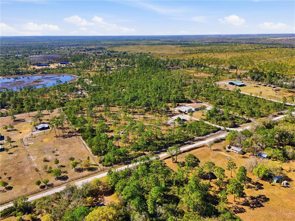 6844 Chad Jason Road St. Cloud, FL 34773 - Photo 55 of 59 an aerial view of residential houses with outdoor space and trees