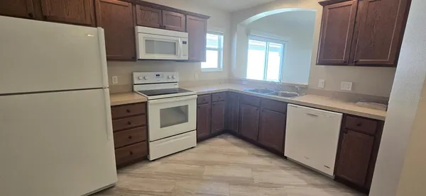 a kitchen with a stove sink and a refrigerator