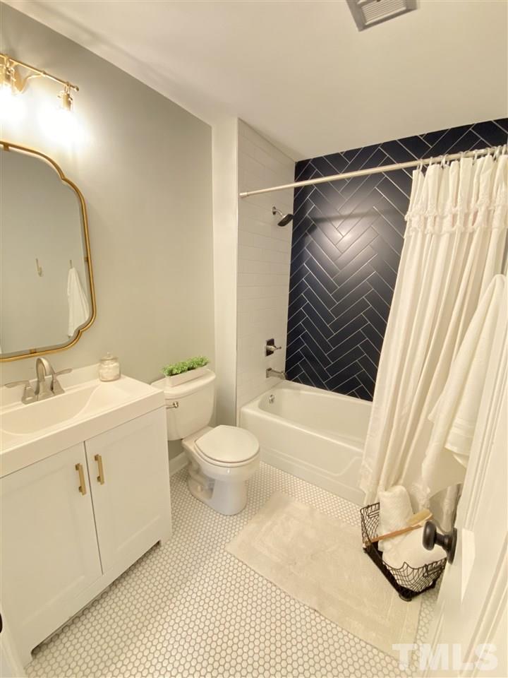 917 Deerfield Road Raleigh, NC 27609 - Photo 13 of 20 a bathroom with a sink a toilet and shower