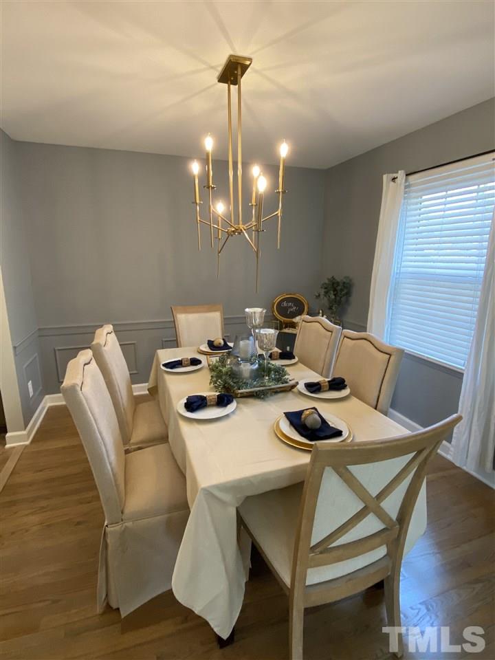 917 Deerfield Road Raleigh, NC 27609 - Photo 7 of 20 a view of a dining room with furniture and wooden floor
