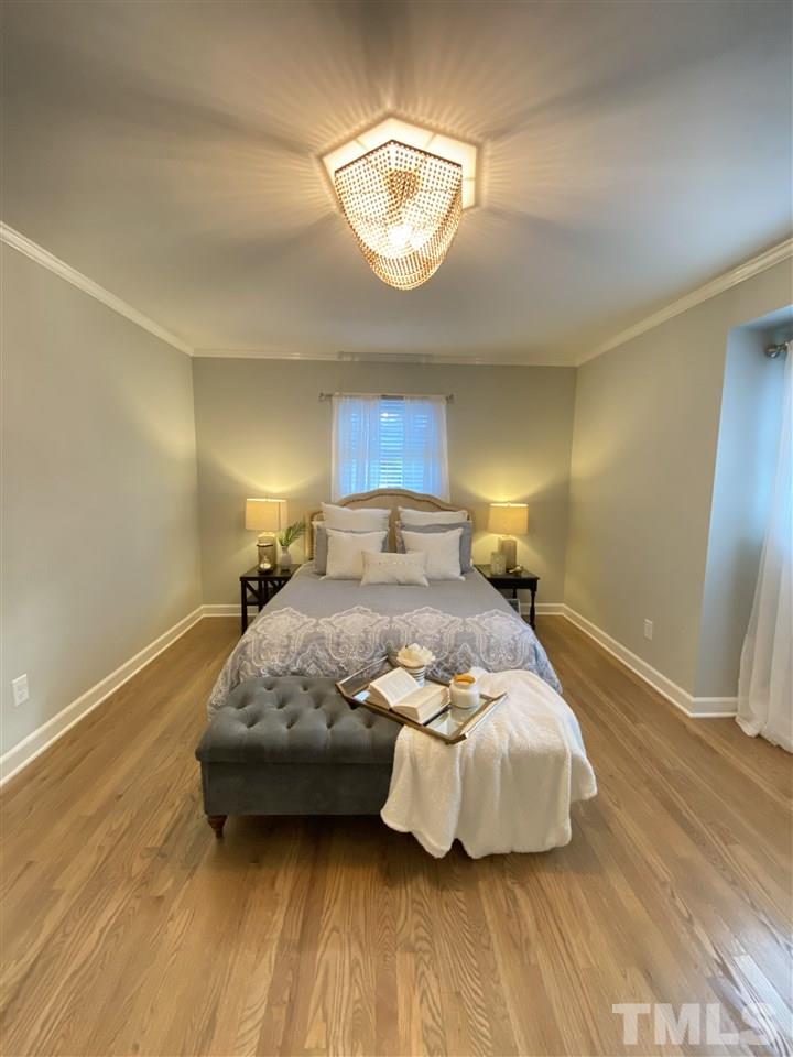 917 Deerfield Road Raleigh, NC 27609 - Photo 10 of 20 a bedroom with a bed and a mirror