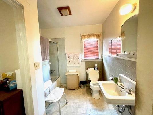 15300 West E Street Kerman, CA 93630 - Photo 11 of 13 a bathroom with a sink mirror and toilet