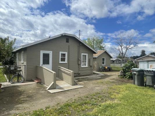 15300 West E Street Kerman, CA 93630 - Photo 3 of 13 a white house that has a tree in front of it