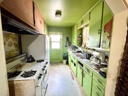 15300 West E Street Kerman, CA 93630 - Photo 7 of 13 a kitchen with lots of counter top space stove and sink