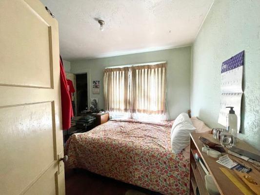 15300 West E Street Kerman, CA 93630 - Photo 8 of 13 a bedroom with a bed and a dresser