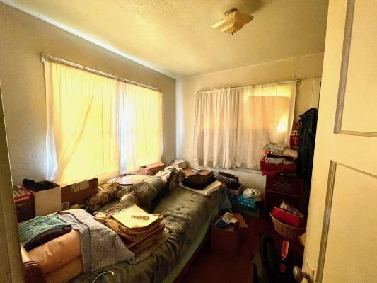 15300 West E Street Kerman, CA 93630 - Photo 9 of 13 a bed sitting in a bedroom next to a window