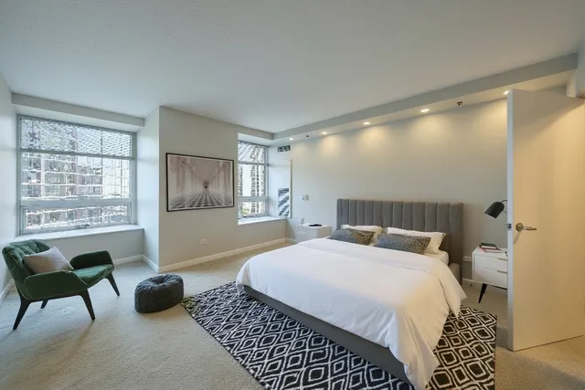 a bedroom with double bed and a large window