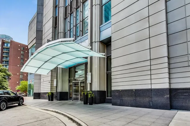a large bedroom with a large bed and a chandelier