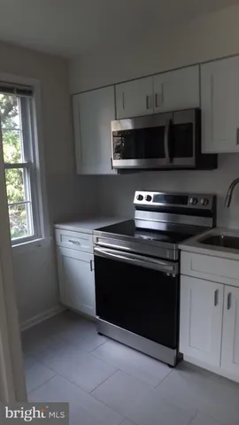 a stove top oven sitting inside of a kitchen