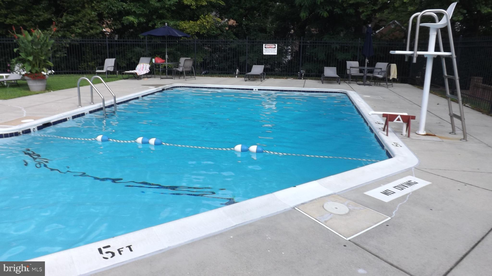 2206 Washington Avenue, Unit 302 Silver Spring, MD 20910 - Photo 25 of 26 a swimming pool with outdoor seating and yard
