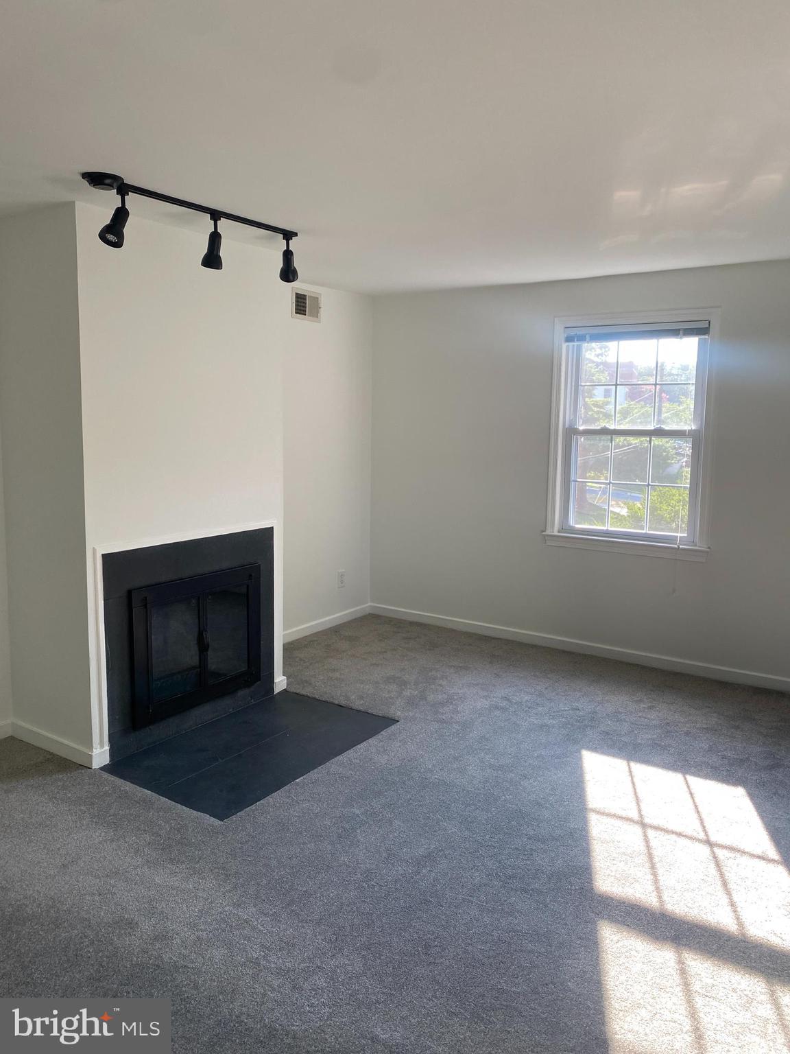 2206 Washington Avenue, Unit 302 Silver Spring, MD 20910 - Photo 6 of 26 a view of an empty room with a window and fireplace