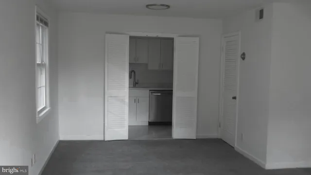a view of an empty room and closet