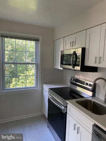 a kitchen with a microwave and a sink