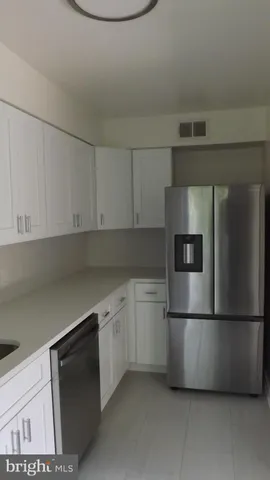 a kitchen with cabinets and stainless steel appliances